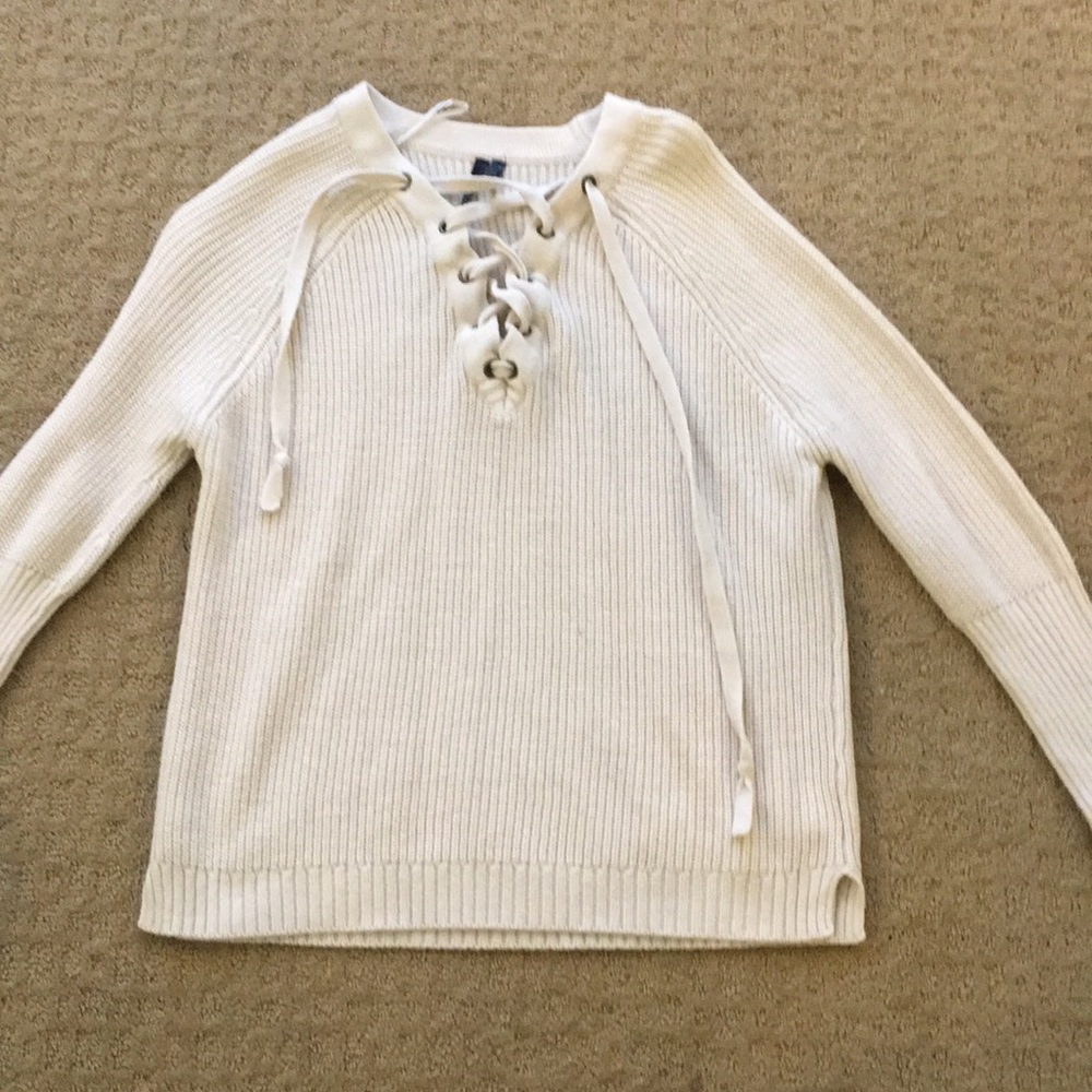 A white lace up sweater